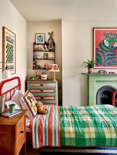 a bedroom with a bed, dressers and a painting on the wall above it