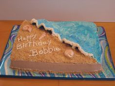 a birthday cake that is made to look like a beach scene