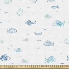 a blue and white fish print fabric on a ruler line, with the background drawn