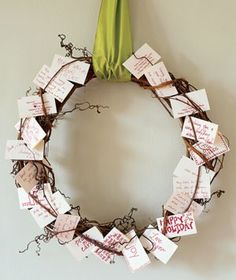 a wreath that has been decorated with notes on it and a green ribbon hanging from the top