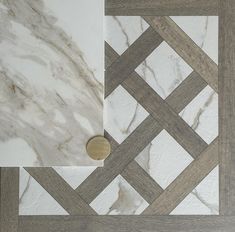 marble and wood flooring with a gold button on it