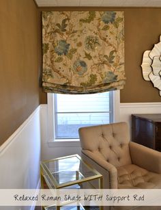 a living room with a chair, table and mirror