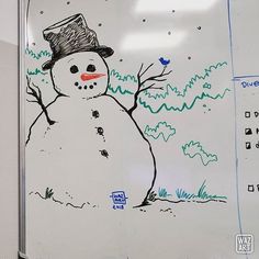 a drawing of a snowman on a white board