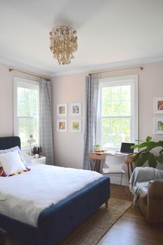 a bedroom with pink walls and blue bedding