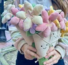 a person holding a bunch of stuffed flowers