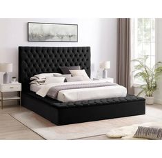 a black bed with white sheets and pillows