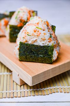 sushi on a wooden cutting board with chopsticks