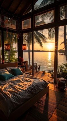 a bed sitting on top of a wooden floor next to a window