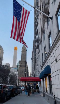 an american flag hanging from the side of a building