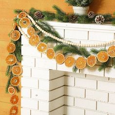 an orange slice garland on a fireplace mantel