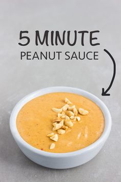 a bowl of peanut butter next to a spoon with peanuts in it and the words 5 minute peanut sauce