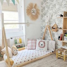 a child's room with a bed, bookshelf and toys