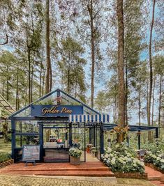 a small blue and white building surrounded by trees