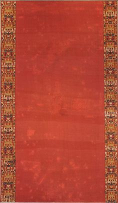 a red rug with an orange border on the bottom and gold trim around the edges