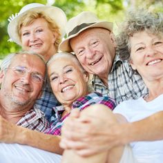 an older couple and two younger people taking a selfie