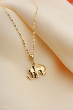 14k Solid Gold Elephant Necklace, Good Luck Charm Necklace, Dainty Gold Pendant, Animal Necklace, Minimalist, Gift for Her, Everyday Jewelry This solid gold dainty Necklace is made entirely from 14k solid gold. * Jewelry is packaged and shipped in a delicate jewelry gift box. * If you are purchasing it as a gift, please feel free to add a personal note. Anniversary, Gift For Wife, Christmas Gift Gold Kt: 14K solid gold * Guaranteed Authentic 14k Gold, NOT Plated Or Filled * Stamp: 14K Elephant Locket Gold, Dainty Necklaces Gold, Elephant Pendant Gold, Fish Pendant Gold, Minimalist Accessories Jewellery, Gold Elephant Pendant, Elephant Necklace Gold, Gold Pendants For Men, Bridal Foot Jewelry