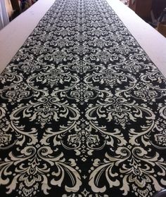 the table is covered with black and white damask fabric, which looks like an intricate design