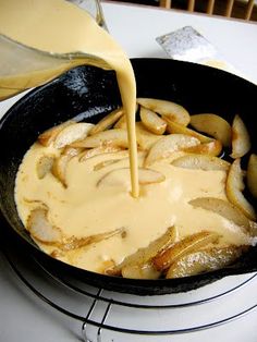 someone is pouring sauce on some food in a skillet