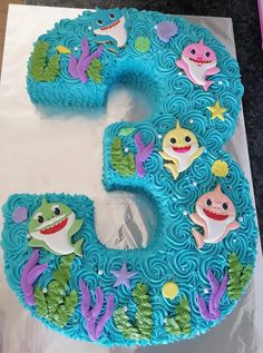 a cake shaped like the number five with sea animals on it