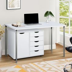 a white desk with drawers and a laptop on it