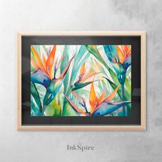 a painting hanging on the wall next to a wooden frame with an image of birds of paradise