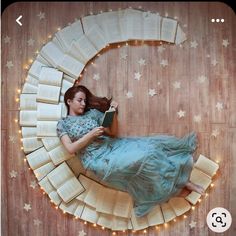 a woman laying on the floor reading a book in a crescent shaped area with stars