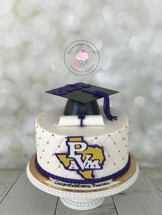 a decorated cake with a graduation cap on top