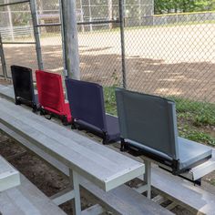 four empty seats are lined up on a bench