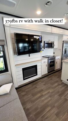 the interior of an rv with white cabinets and wood flooring is shown in this photo