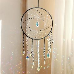 a dream catcher hanging from the side of a window