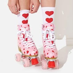 a pair of pink roller skates with hearts on them