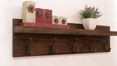 a wooden shelf with several books on it and a potted plant in the corner