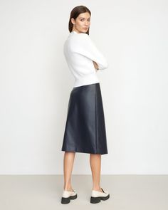 A sleek, asymmetric midi cut from soft vegan leather — Alba is the perfect staple you'll reach for season after season. We love to style this skirt with a cozy sweater and tall boots for a chic winter look. See below for our general Size Guide and available measurements Self made of 100% polyurethane, lining made of 100% polyester Machine wash cold and tumble dry low Leather Midi Skirt For Work, Modern Skirt With Asymmetrical Hem For Work, Sleek Midi Skirt For Fall, Spring Leather Midi Skirt, Spring Leather Midi-length Skirt, Versatile Knee-length Skirt For Fall, Versatile Workwear Skirt For Fall, Sleek Lined Skirt For Fall, Winter Leather Midi Skirt