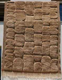 a close up of a building with a wall made out of squares and rectangles