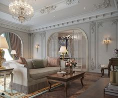 a living room with couches, tables and chandeliers on the walls in front of windows