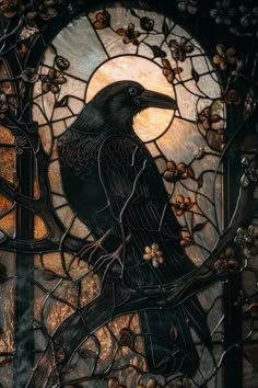 a black bird sitting on top of a tree branch in front of a stained glass window