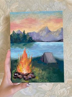 a painting of a campfire in front of a lake with a tent on it