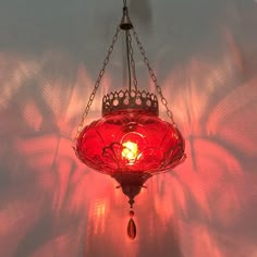 a red light hanging from the ceiling in a room