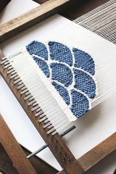 a weaving machine with blue and white designs on it