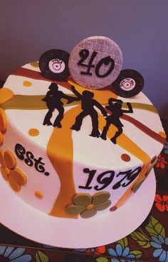 a birthday cake decorated with the number forty and people holding hands on top of it