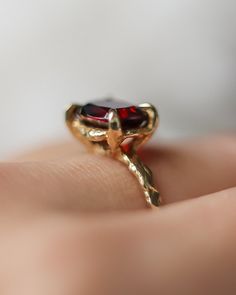 A garnet gemstone sparkles in this hand carved claw setting. Whether a gift for someone you hold close or a treat for yourself, this solid gold garnet ring is perfect to mark a special moment or adventure never to forget. Details:- 3.5 carat antique cushion cut garnet gemstone set "east-west"- Available in 10k yellow or white gold, or 14k, yellow, rose or white gold- Finish: polished (can be matte satin upon request) Individually handcrafted just for you in Lacee’s beach side studio in Long Beac Gold Garnet Ring, Sculpted Jewelry, Antique Cushion Cut, Statement Engagement Ring, Unique Bridal Jewelry, Antique Cushion, Blue Sapphire Necklace, Beach Side, Cushion Cut Engagement Ring