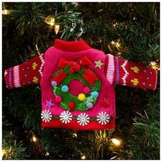 a christmas sweater ornament hanging from a tree