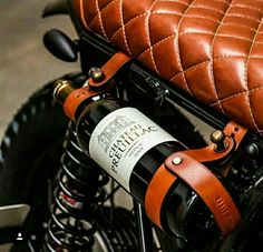 a close up of a wine bottle on a motorcycle