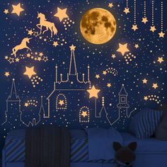 a child's room with stars, moon and castle wall decals