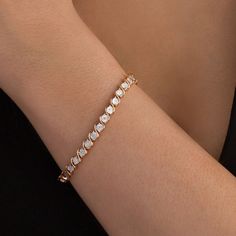 Wear this smart diamond tennis bracelet any time for a great touch of classic dazzle. Crafted in sterling silver with 14K rose gold plate, this enticing design features shimmering diamonds - artfully set to enhance size and sparkle - and beaded circles alternating with polished "S" shaped links. Captivating with 1/10 ct. t.w. of diamonds and a bright polished shine, this 7.25-inch bracelet secures with a tongue and groove clasp. Rose Gold Diamond Tennis Bracelet With Jubilee Style, Rose Gold Diamond Tennis Bracelet With Prong Setting, Rose Gold Diamond Tennis Bracelet Brilliant Cut, Rose Gold Diamond Jubilee Bracelet, Rose Gold Diamond Bracelet With Vvs Clarity, Rose Gold Bracelets With Diamond Accents For Anniversary, Everyday Luxury Rose Gold Diamond Bracelet With Brilliant Cut, Everyday Luxury Rose Gold Cubic Zirconia Tennis Bracelet, Rose Gold Everyday Luxury Tennis Bracelet