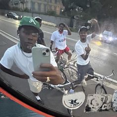 a man taking a selfie with his cell phone in front of him on the street