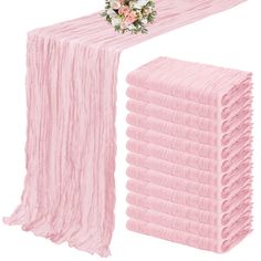 a stack of pink tissue next to a bouquet of flowers on top of each other