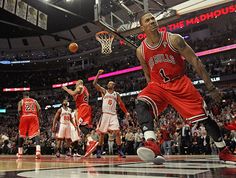 a basketball player dribbling the ball in front of other players during a game