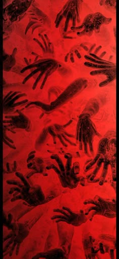 an image of many different handprints on the ground in red and black colors