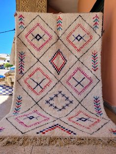 an old rug is sitting on the ground